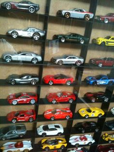 a display case filled with lots of toy cars