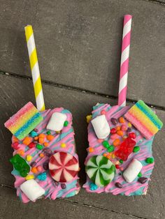 there are two pieces of cake made to look like candy houses with marshmallows and candies on them