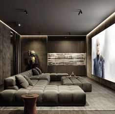 a living room with large couches and a flat screen tv on the wall behind it