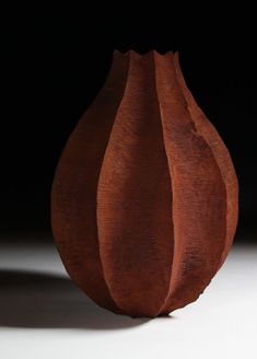 a brown vase sitting on top of a white table