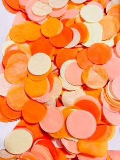 orange and pink confetti circles are scattered on top of each other in this image