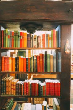 a bookshelf filled with lots of different colored books