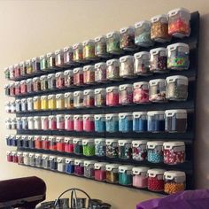 the wall is filled with lots of different colored sprinkles and other craft supplies