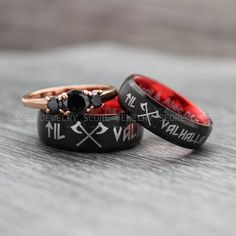 two black and red wedding rings with skulls on them