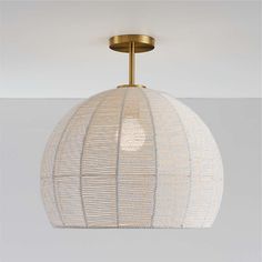 a white and gold light fixture hanging from the ceiling