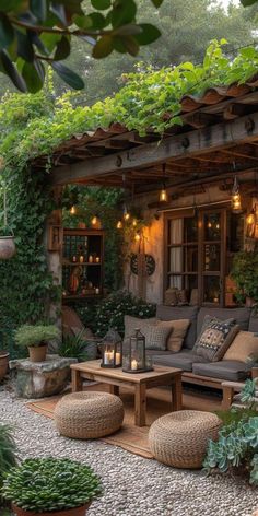 an outdoor living area with couches, tables and potted plants