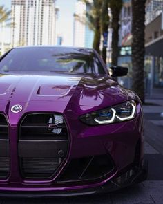 the front end of a purple sports car