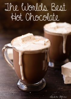 two glasses filled with hot chocolate and marshmallows