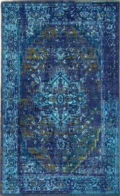 a blue rug with an ornate design on the front and back side, in various colors