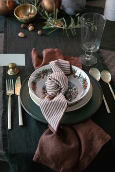 a place setting with plates, silverware and napkins