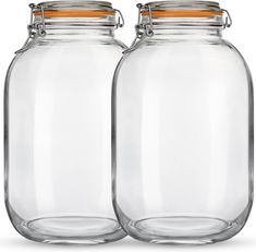 two clear glass jars with metal lids on each one and an orange stripe at the top