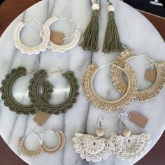 a marble table topped with lots of earrings