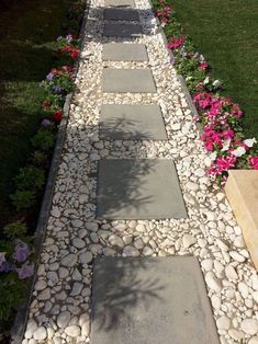 a walkway made out of stones and flowers