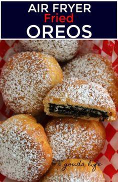 powdered sugar covered fried oreos on a red and white checkered table cloth