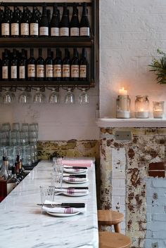 a table with wine glasses and candles on it