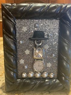 a photo frame with a clock and hat on it