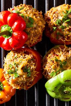 several different types of food on a grill with peppers and jalapenos in the background