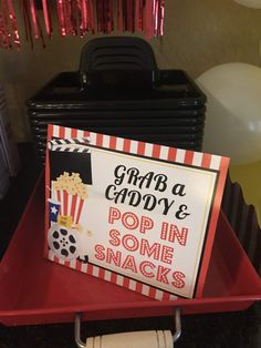 there is a sign that says grab a goody and pop in some snacks on the table