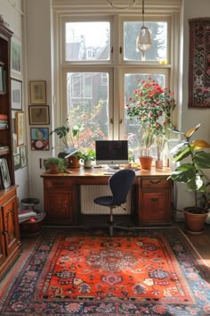 a room with a desk, chair and rug on the floor in front of a window