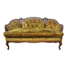 an old fashioned couch with gold velvet upholstered