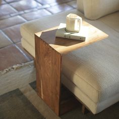 a coffee table with a book on it and a cup sitting on top of it