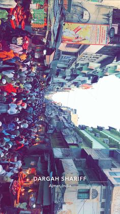 an overhead view of many people walking down the street with umbrellas hanging above them