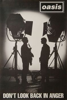 two men standing in front of camera equipment with the words oasis on it's side