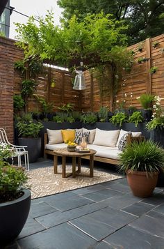 an outdoor living area with potted plants and furniture