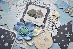 a close up of some paper and doily on a table with blue flowers in the center