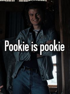 a man standing in front of a window with his arms crossed and the words pokie is pokie