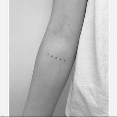 a person's arm with the word trust tattooed on it, in black and white