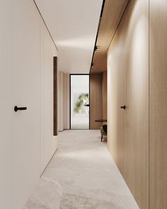 an empty hallway is shown with white walls and wood paneling on the side wall