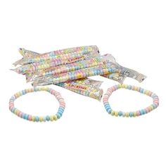 three bracelets with colorful beads on them and one has an airplane shaped object in the middle