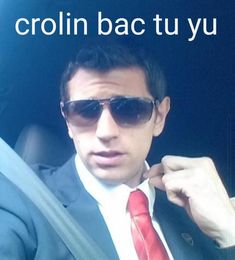 a man wearing sunglasses and a red tie sitting in a car with the caption crollin bac tu yu