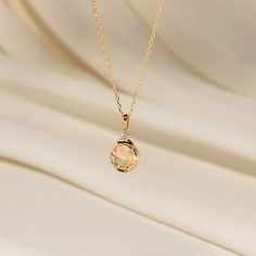 Embrace the beauty of this one-of-a-kind opal pebble necklace, designed to be as unique as you are. With its organic wave patterns on one side and a sleek, smooth finish on the other, it invites you to express yourself. The polished back is perfect for soothing moments, allowing you to rub it like a worry stone whenever you need a bit of calm. This necklace isn’t just an accessory; it’s a piece you’ll cherish now and one you can pass down, sharing its beauty and story with future generations. Le Baguette Necklace, Pebble Necklace, Love Knot Ring, Solid Gold Bracelet, Oval Locket, Flat Back Earrings, Diamond Jewelry Necklace, Solid Gold Necklace, Solid Gold Earrings