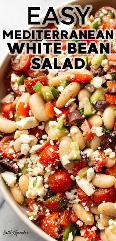 a white bean salad with tomatoes, cucumbers and feta cheese in a bowl