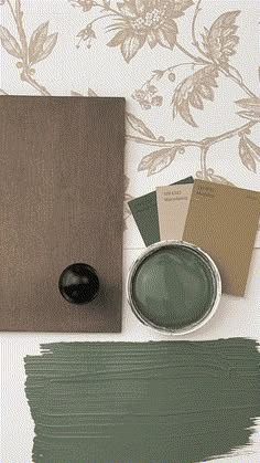 the paint is green and there are some colors on the table next to it,