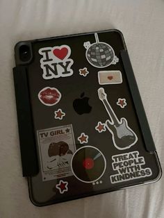 an ipad case with various stickers on it