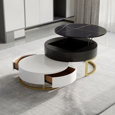 a modern coffee table with two circular tables on each side and an open drawer in the middle