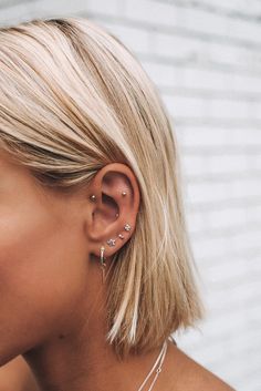 a close up of a person wearing ear piercings