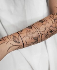 a woman's arm with flowers on it