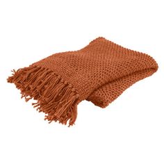 an orange knitted blanket with fringes