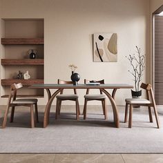 a dining room table with four chairs and a vase on the table in front of it