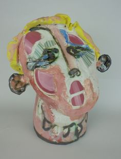 a ceramic head is painted with various colors