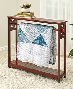 a wooden shelf with a quilt on it