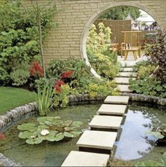 an outdoor garden with water lilies and stepping stone steps leading up to the pond