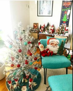 a christmas tree in a living room with santa clause decorations on it and other holiday decor