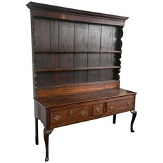 an old wooden desk with two drawers and a shelf on one side, against a white background