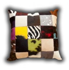 a multicolored patchwork pillow is shown on a white background, with an animal print