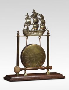 an antique clock with a sailing ship on it